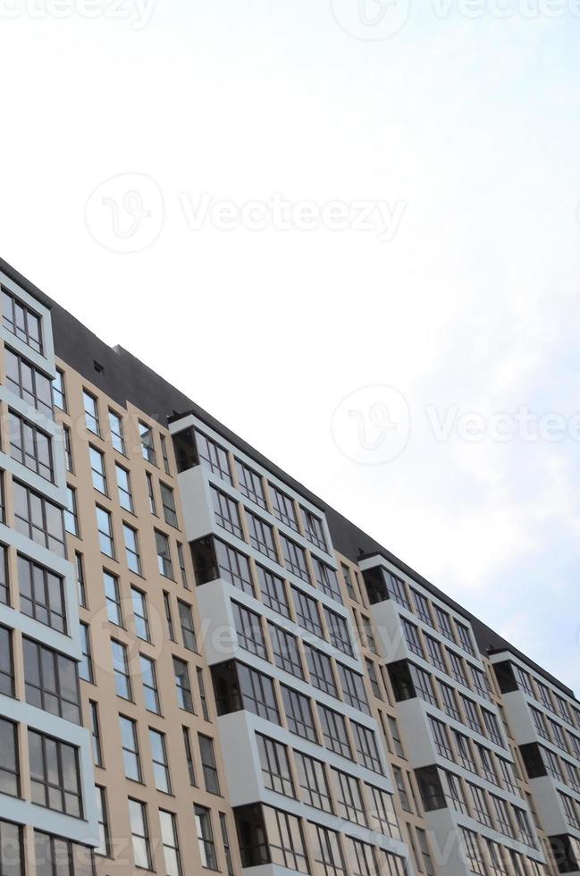 New multy storey residential building on the city street photo