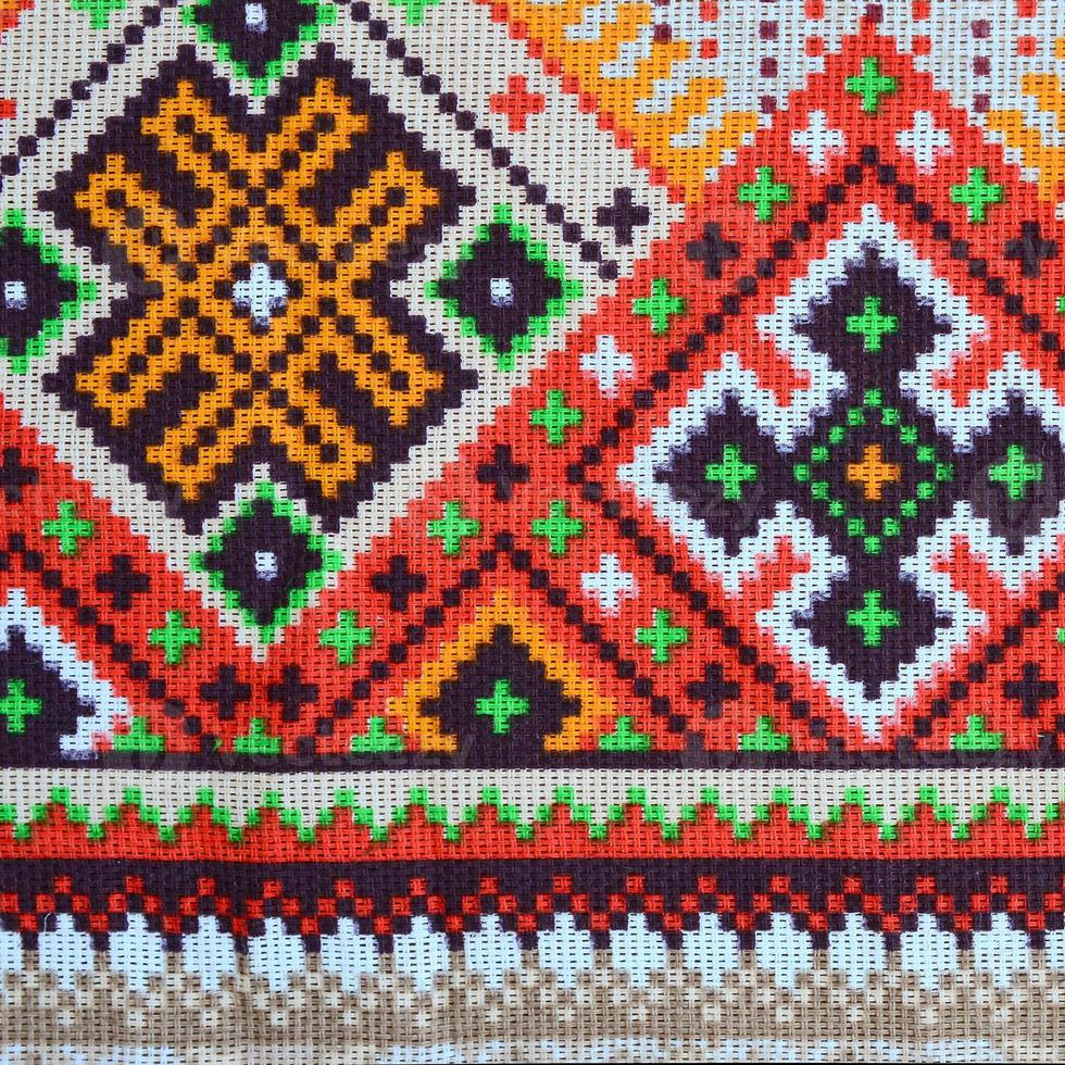 Traditional Ukrainian folk art knitted embroidery pattern on textile fabric photo