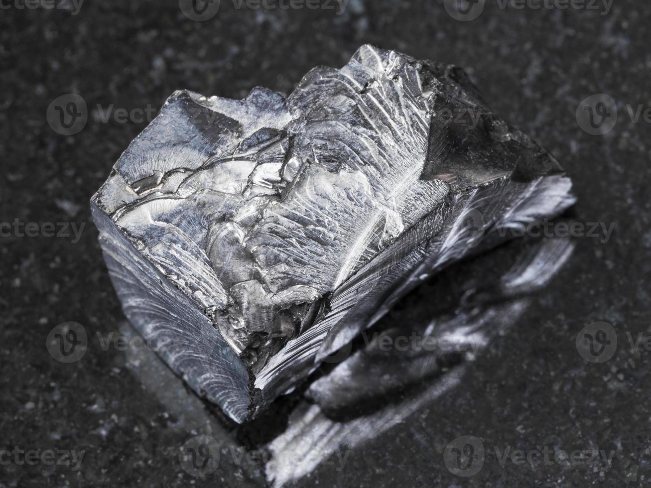 shungite stone on dark background photo