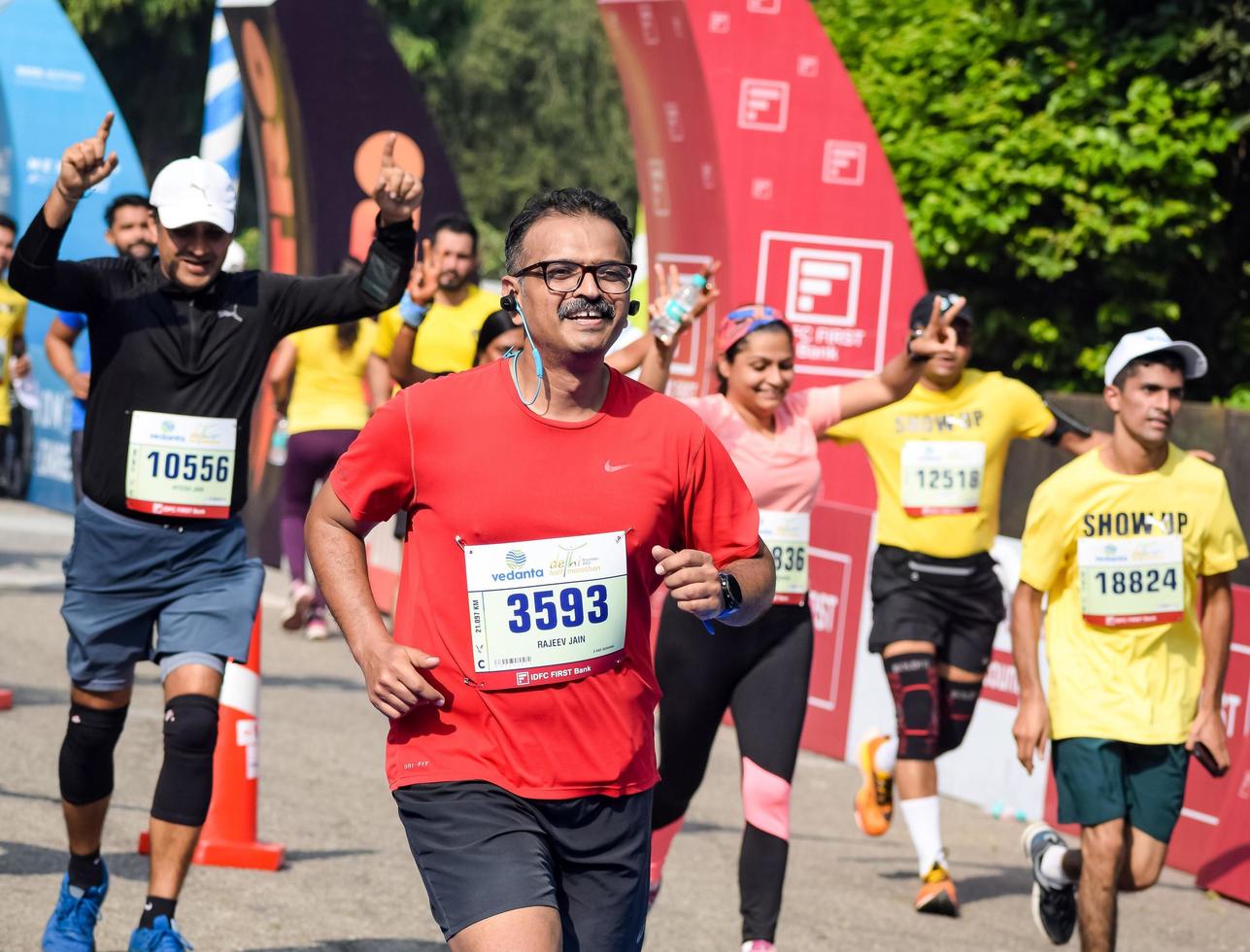 nueva delhi, india - 16 de octubre de 2022 - carrera de media maratón de vedanta delhi después de covid en la que los participantes del maratón están a punto de cruzar la línea de meta, media maratón de delhi 2022 foto