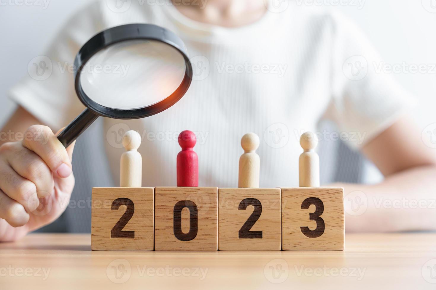 2023 block with magnifying glass and people. hiring, employee, recruitment, job and jobless concept photo