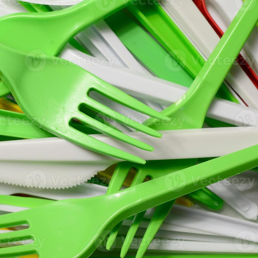 Pile of bright yellow, green and white used plastic kitchenware
