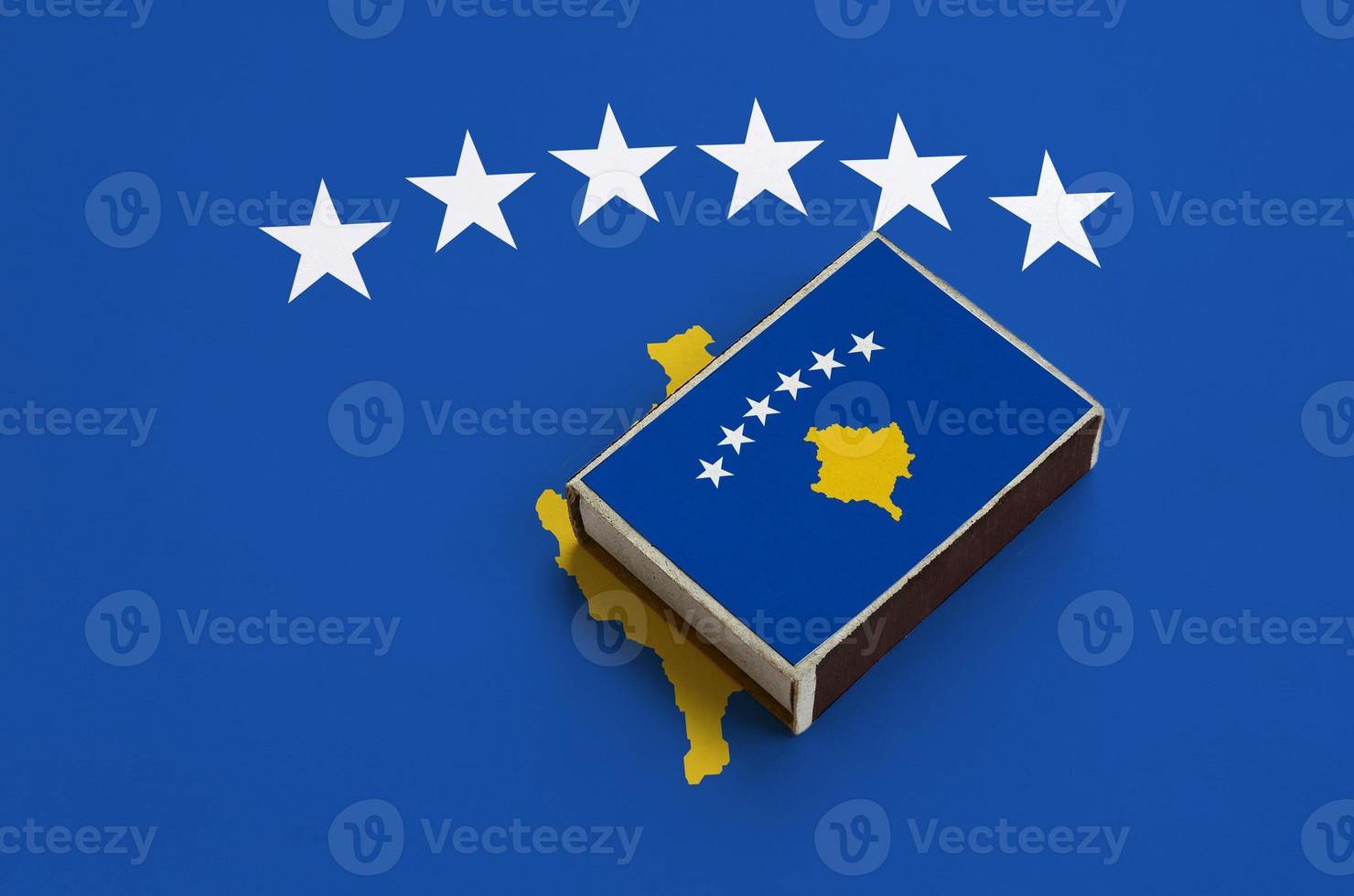 Kosovo flag is pictured on a matchbox that lies on a large flag photo
