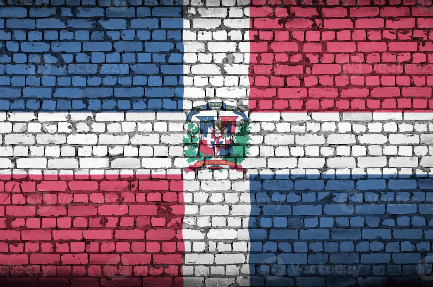 Dominican Republic flag is painted onto an old brick wall photo