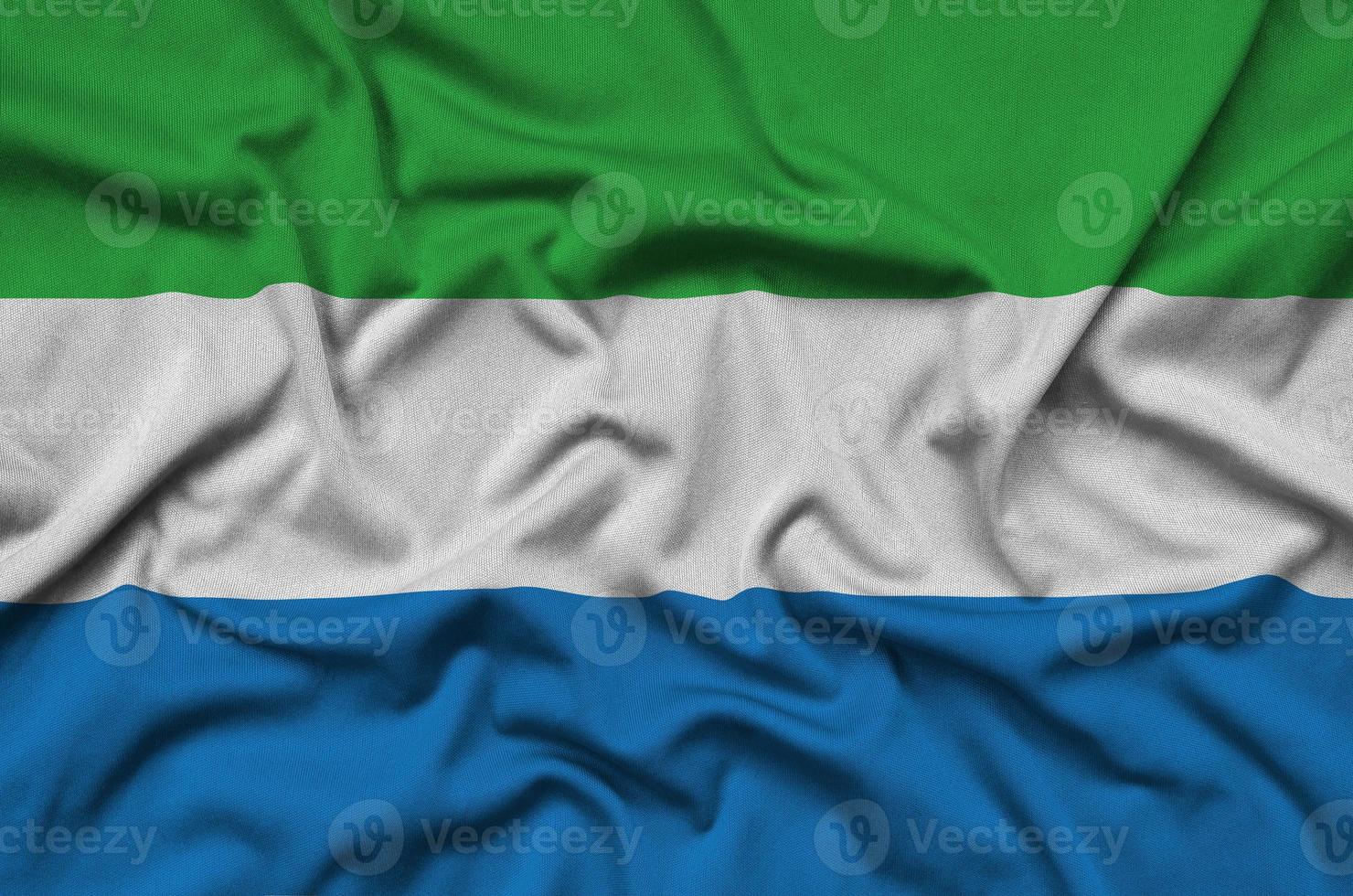 Sierra Leone flag is depicted on a sports cloth fabric with many folds. Sport team banner photo