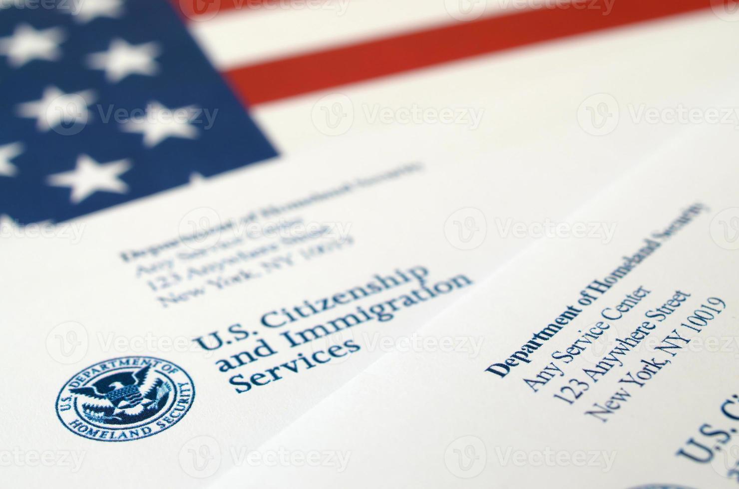 Envelopes with letter from USCIS on United States flag from Department of Homeland Security photo