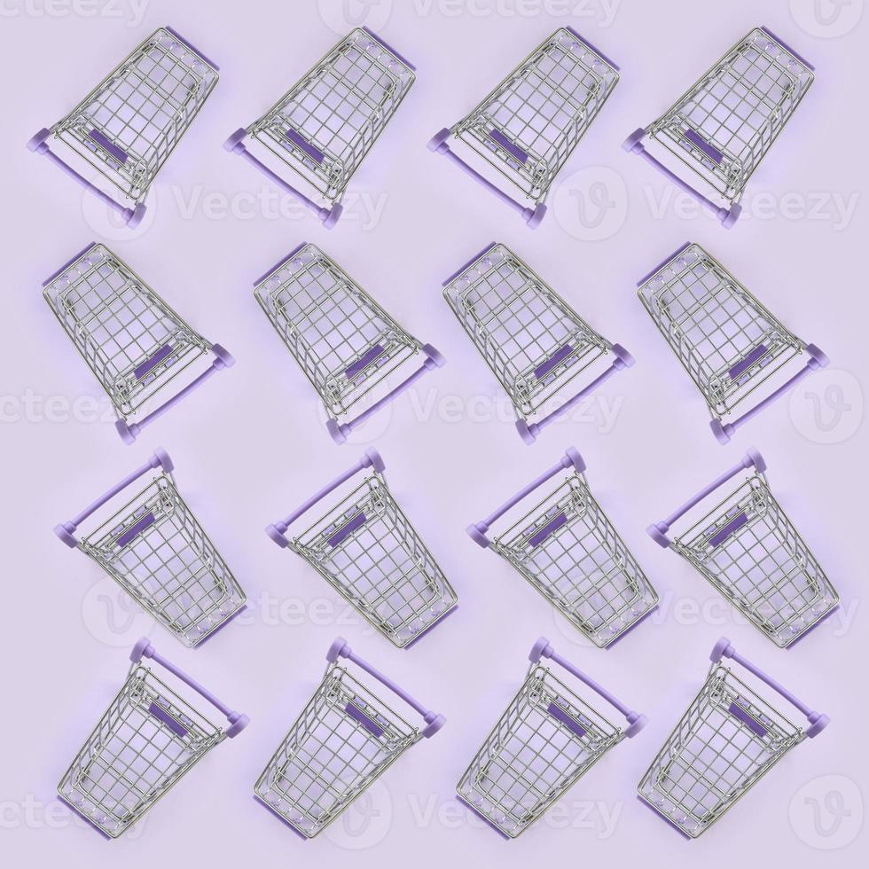 Pattern of many small shopping carts on a violet background. Minimalism flat lay top view photo