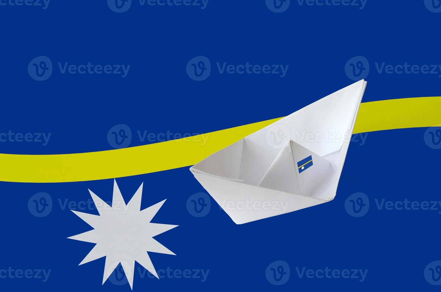 Nauru flag depicted on paper origami ship closeup. Handmade arts concept photo
