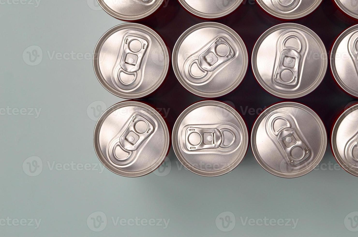 Many new aluminium cans of soda soft drink or energy drink containers. Drinks manufacturing concept and mass production photo