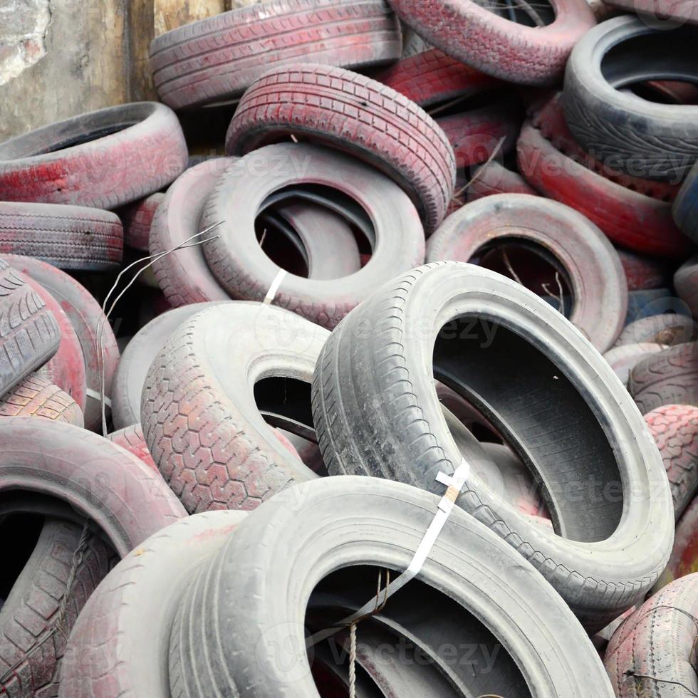 A picture of many old used tires left on a waste dump photo