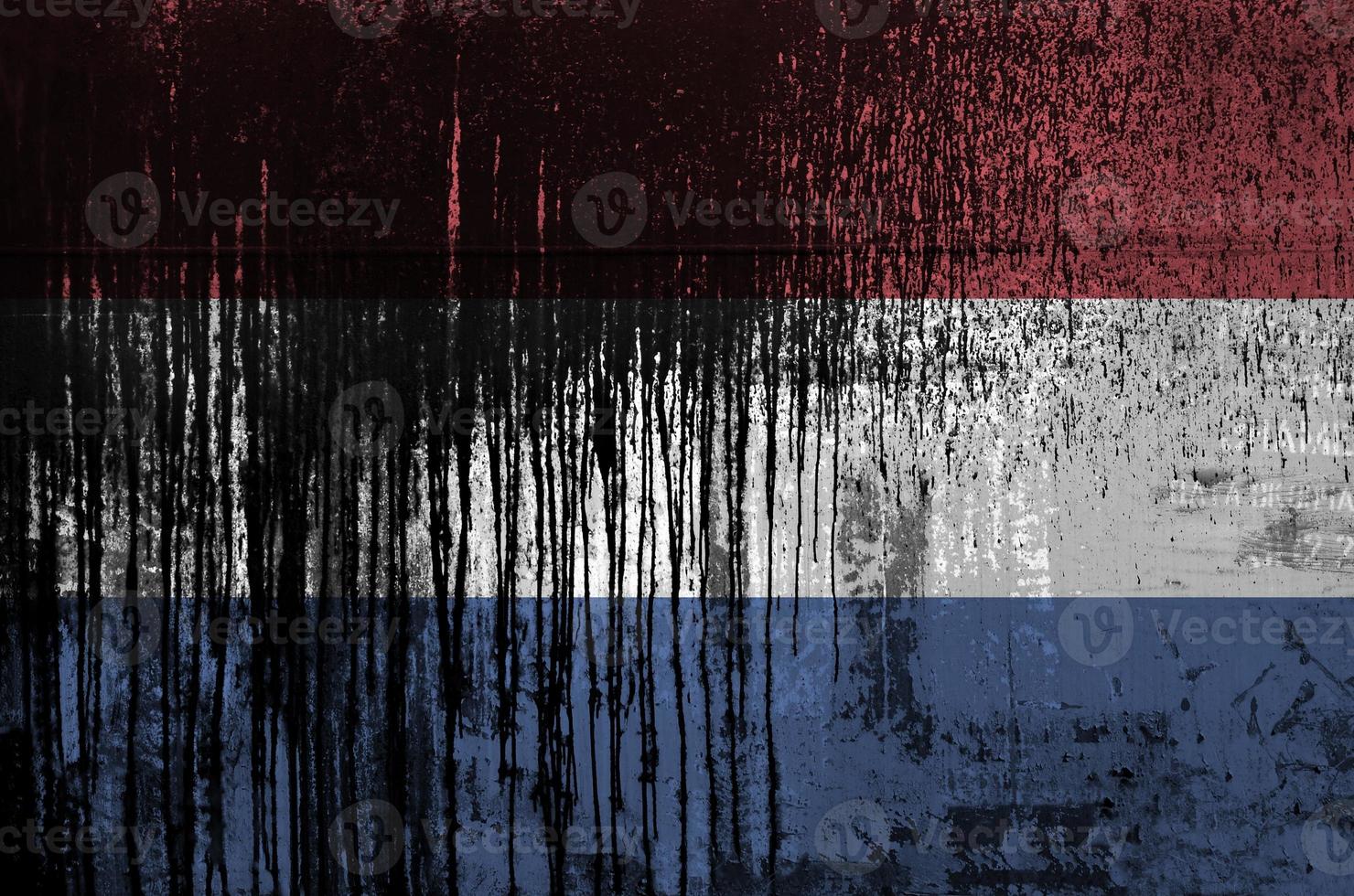 Netherlands flag depicted in paint colors on old and dirty oil barrel wall closeup. Textured banner on rough background photo