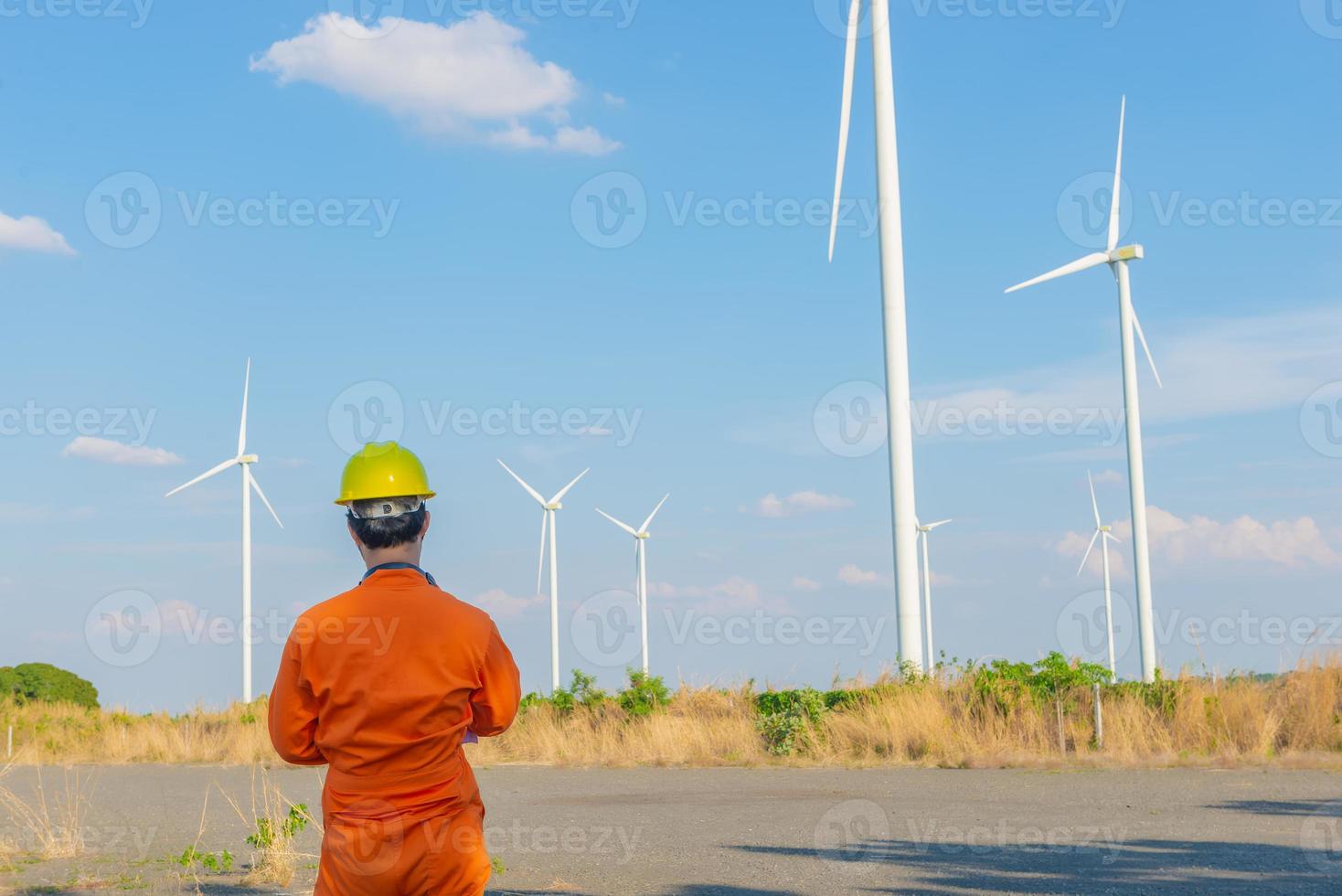 silueta de hombre ingeniero trabajando y sosteniendo el informe en la estación generadora de energía de la granja de turbinas eólicas en la montaña, gente de tailandia foto