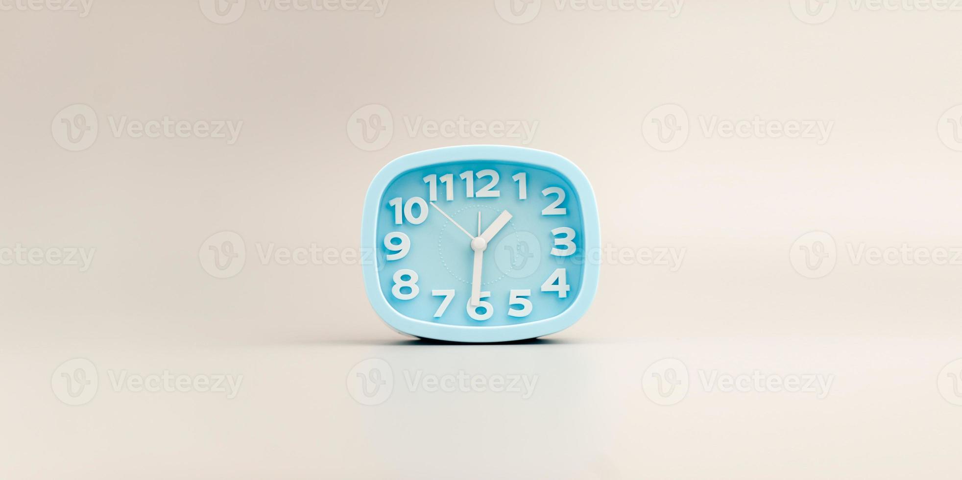 blue alarm clock on gray background time concept photo