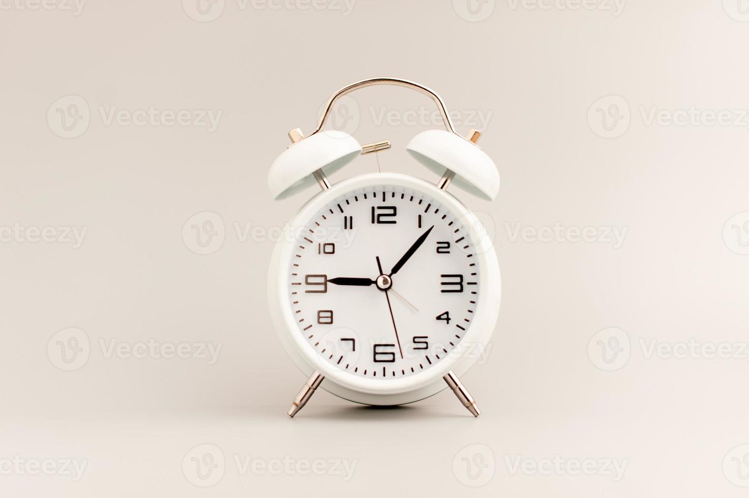 White clock on gray background, time concept that matters to life and work. photo