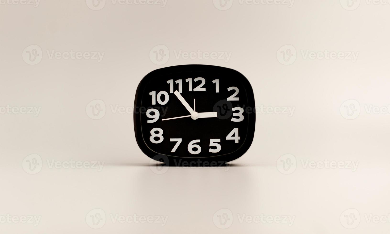 Black clock on gray background, time concept that matters to life and work. photo