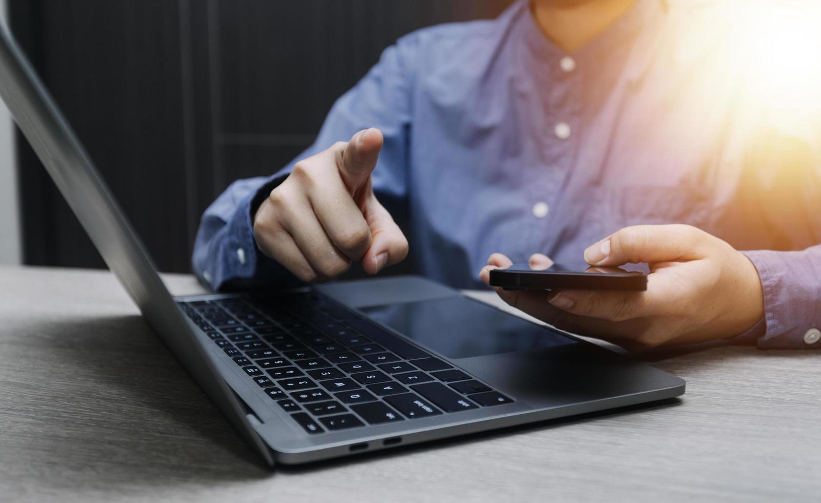 businesswoman hand working with laptop computer, tablet and smart phone in modern office with virtual icon diagram at modernoffice in morning light photo
