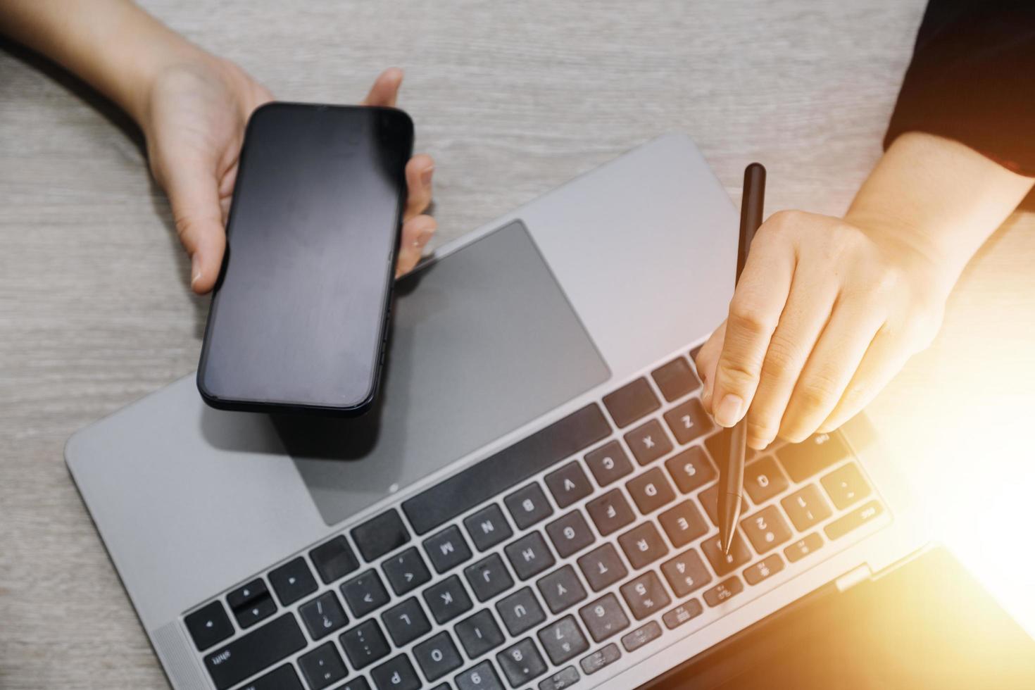 businesswoman hand working with laptop computer, tablet and smart phone in modern office with virtual icon diagram at modernoffice in morning light photo