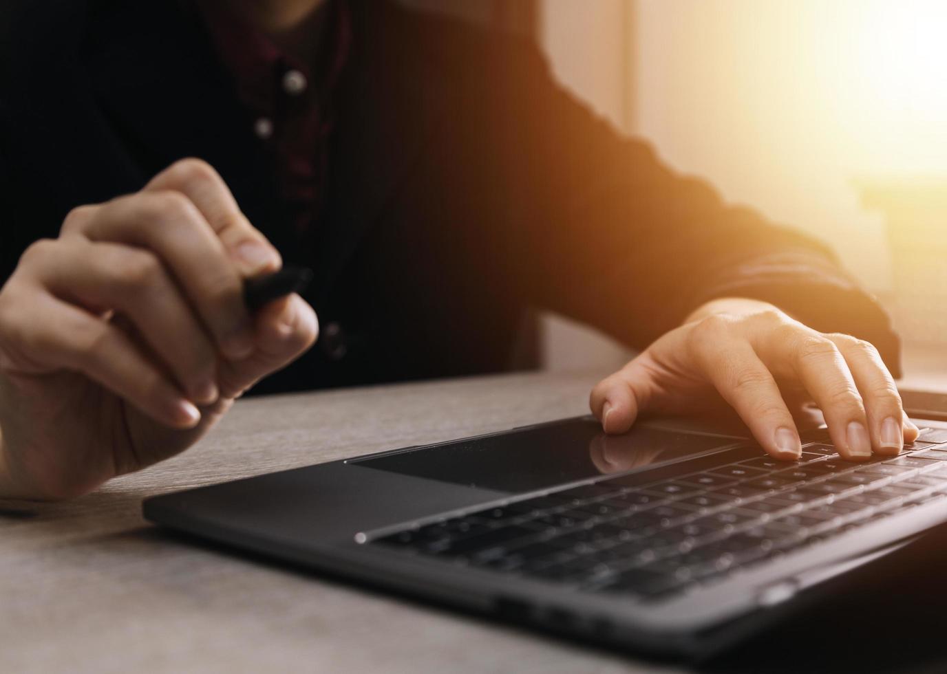 businesswoman hand working with laptop computer, tablet and smart phone in modern office with virtual icon diagram at modernoffice in morning light photo