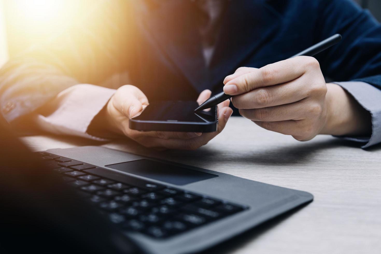 businesswoman hand working with laptop computer, tablet and smart phone in modern office with virtual icon diagram at modernoffice in morning light photo