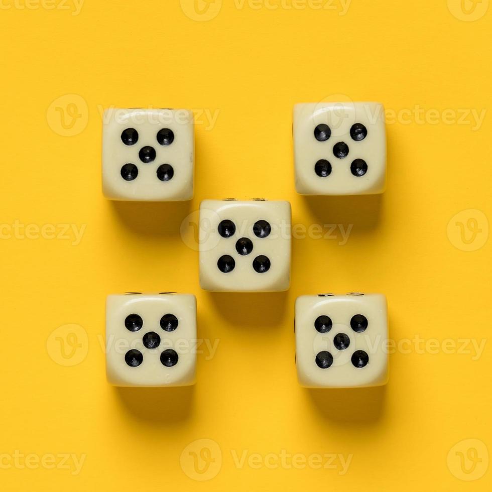 Ideally placed dice, their number and value are the same, on a yellow background. Top view. photo