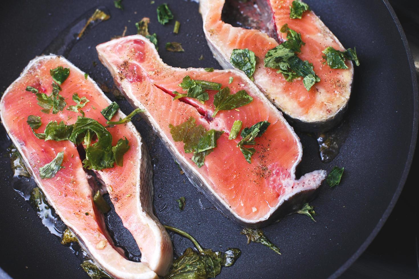 Raw trout steaks in frying pan, top view. photo