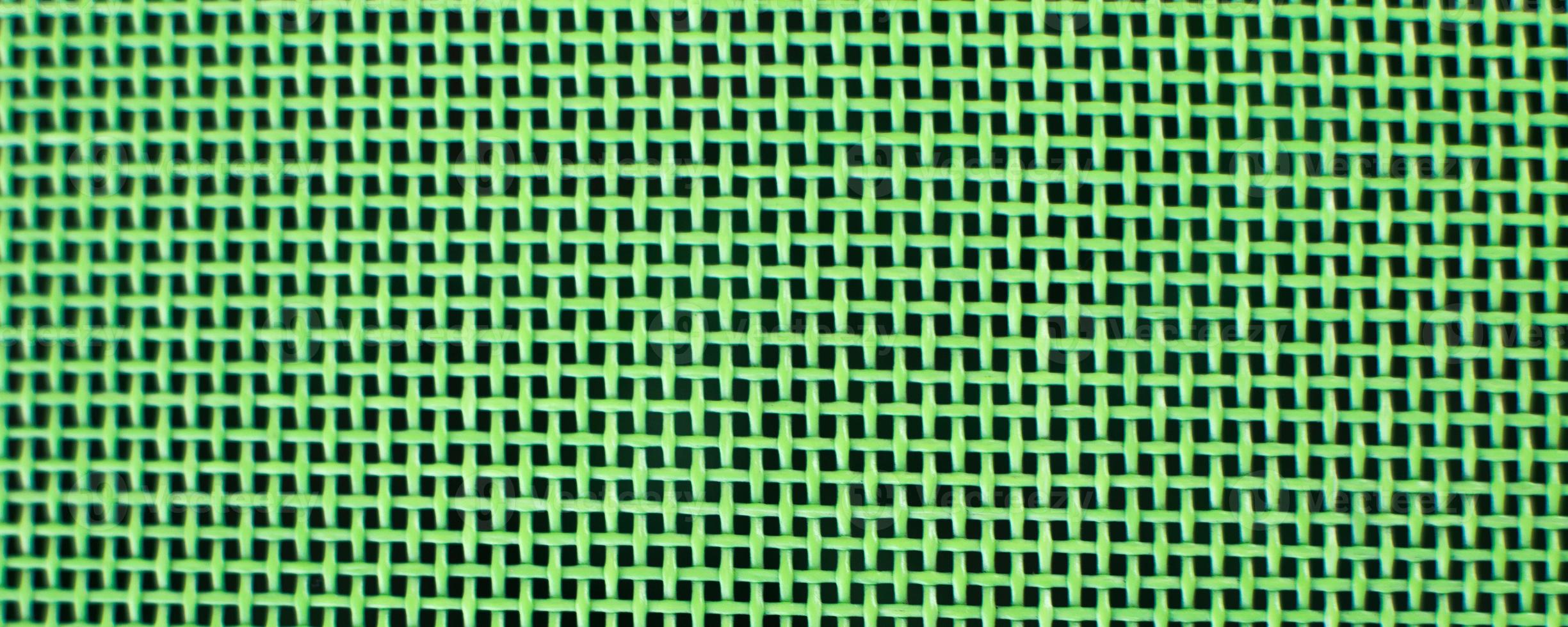 Weaving or mesh pattern background. green plastic texture photo