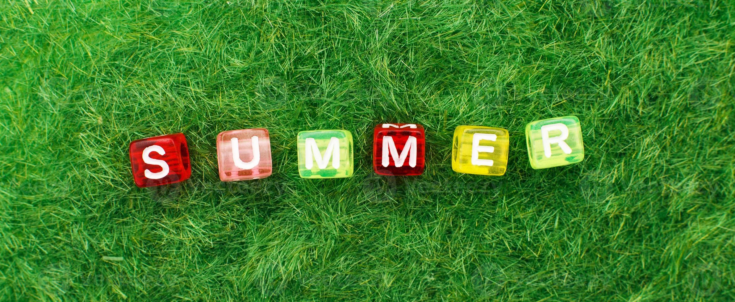 word summer on green grass background. lawn desktop nature pattern. banner photo