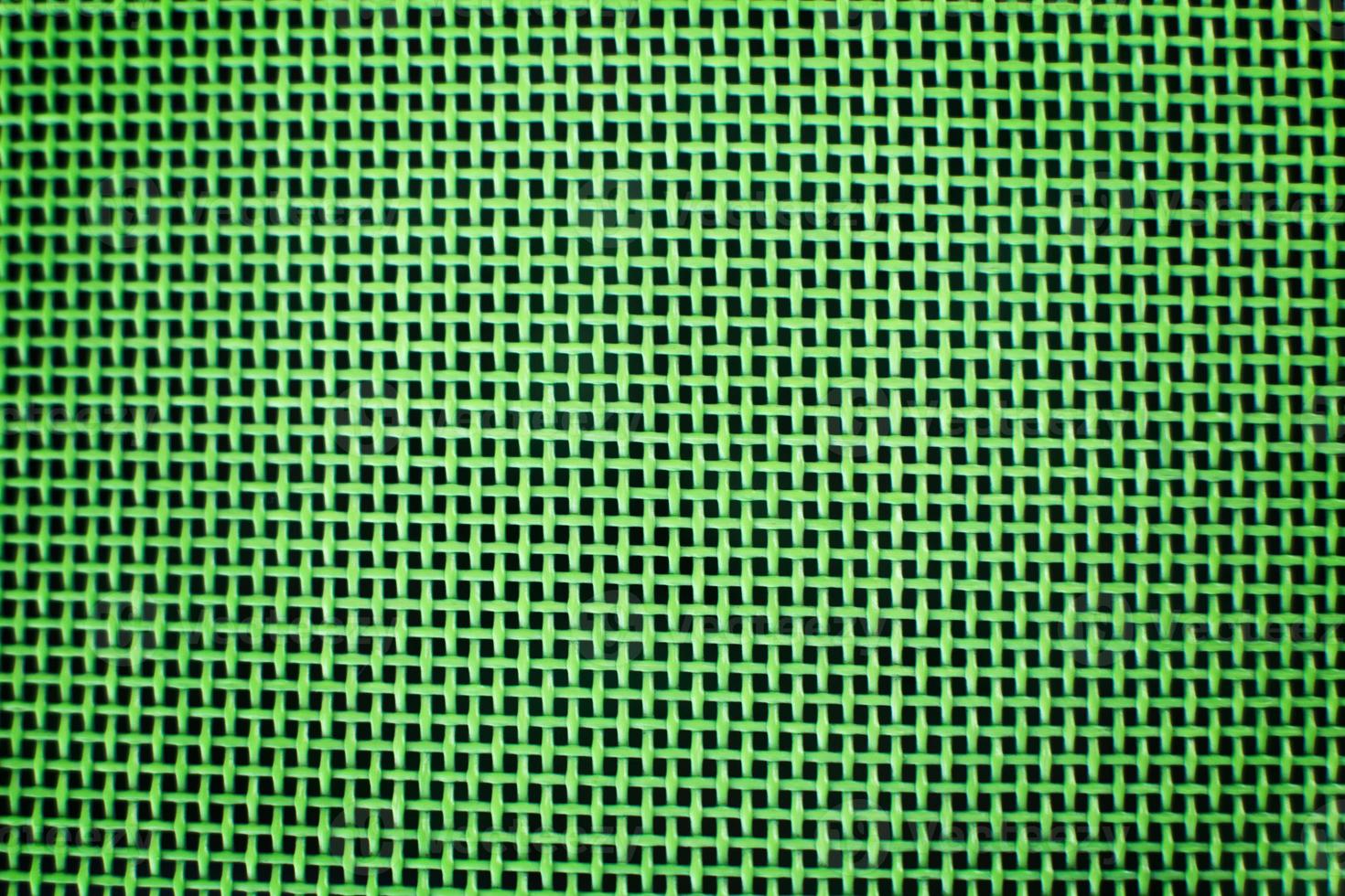Weaving or mesh pattern background. green plastic texture photo