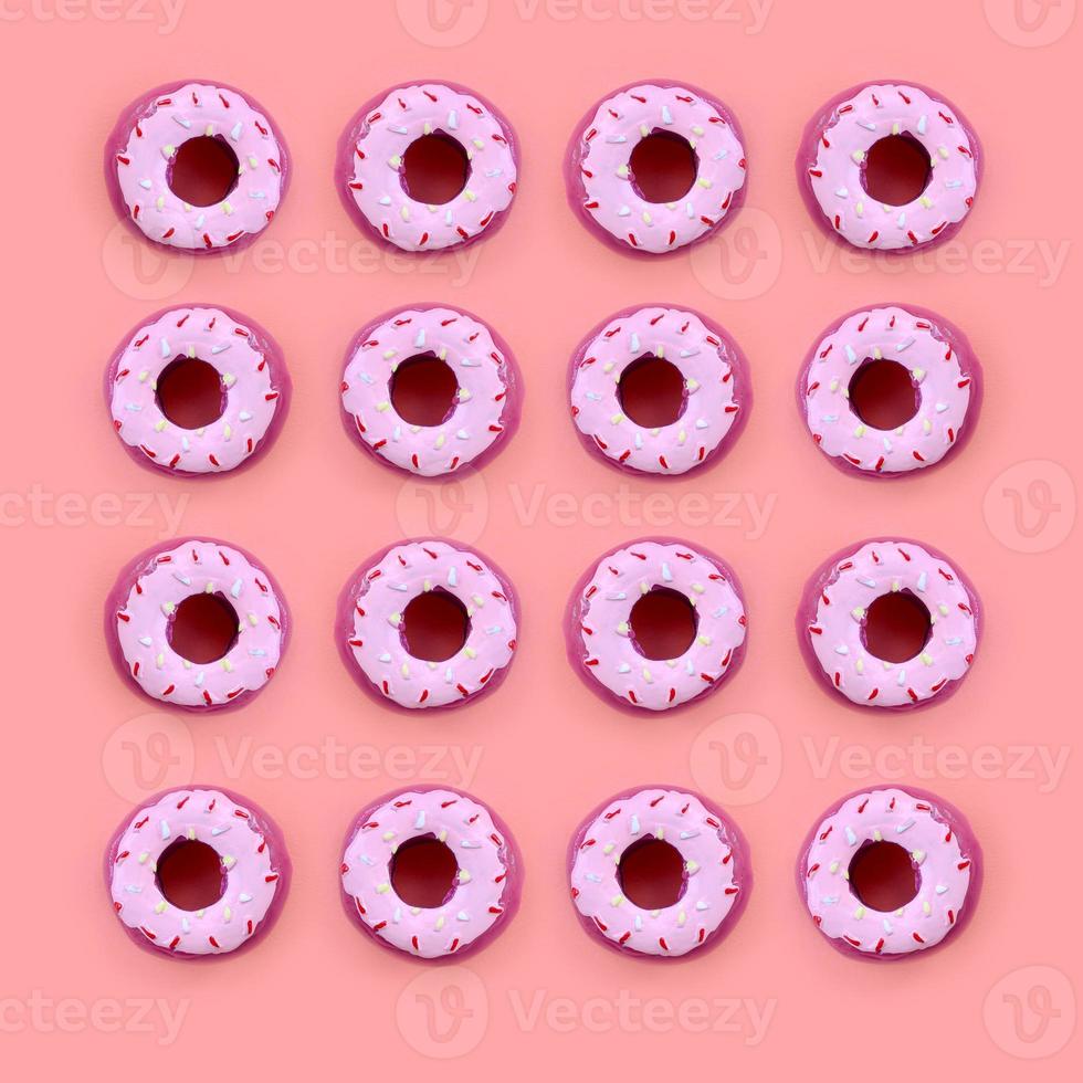 Many small plastic donuts lies on a pastel colorful background. Flat lay minimal pattern. Top view photo