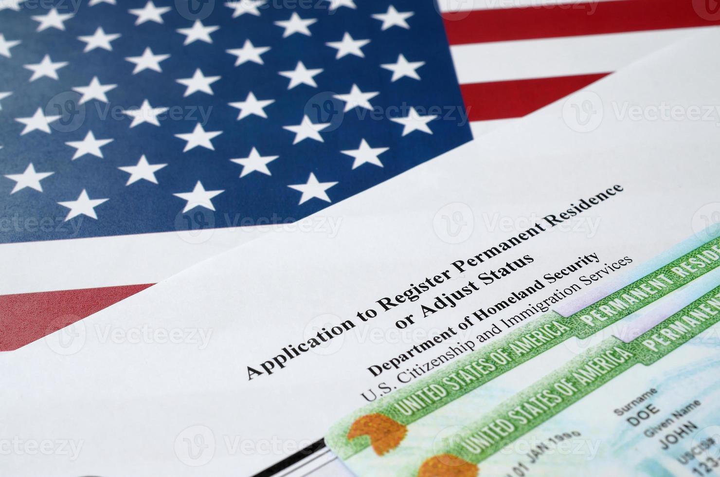 I-485 Application to register permanent residence or adjust status form and green card from dv-lottery lies on United States flag from Department of Homeland Security photo