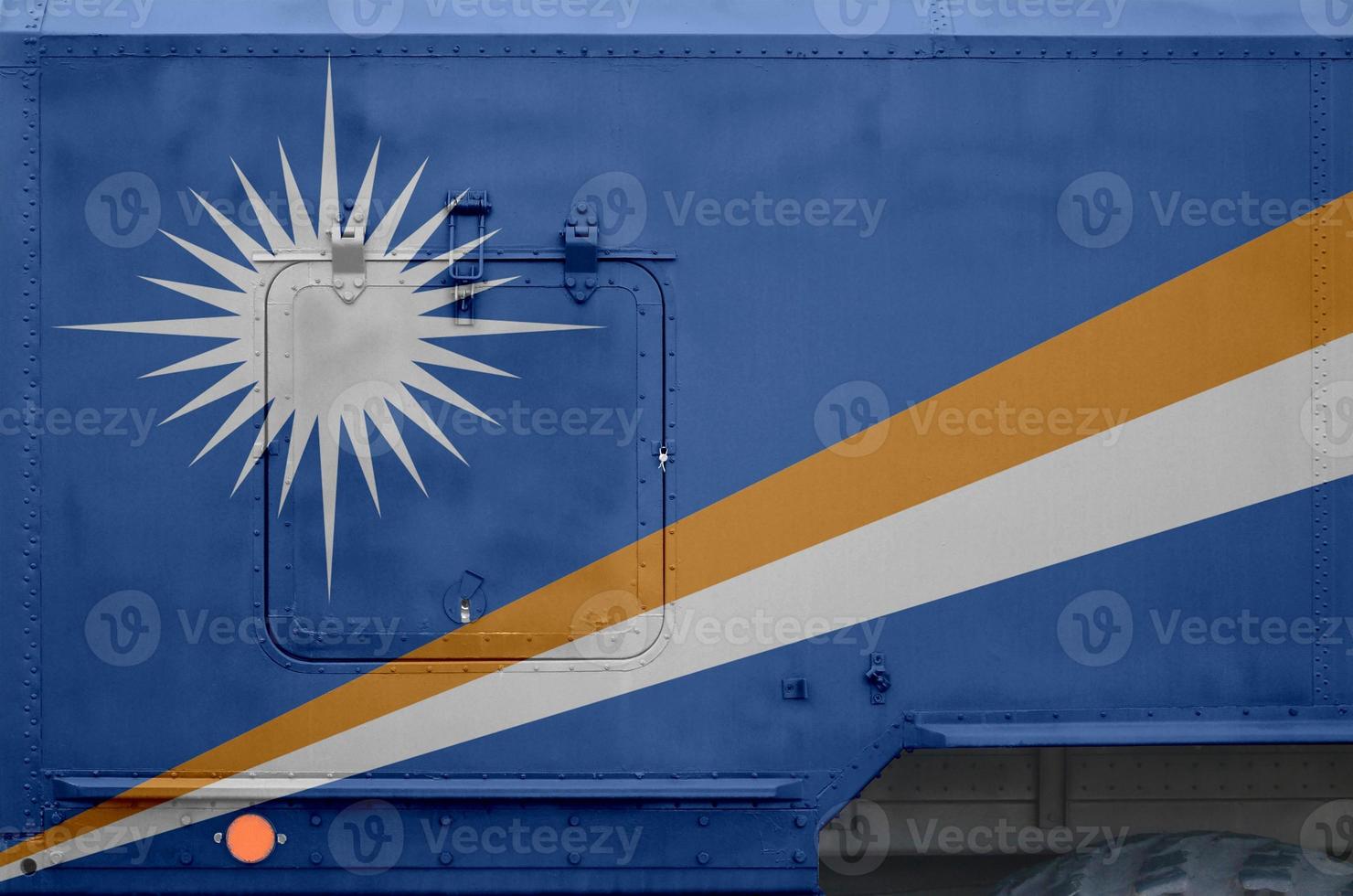 Marshall Islands flag depicted on side part of military armored truck closeup. Army forces conceptual background photo