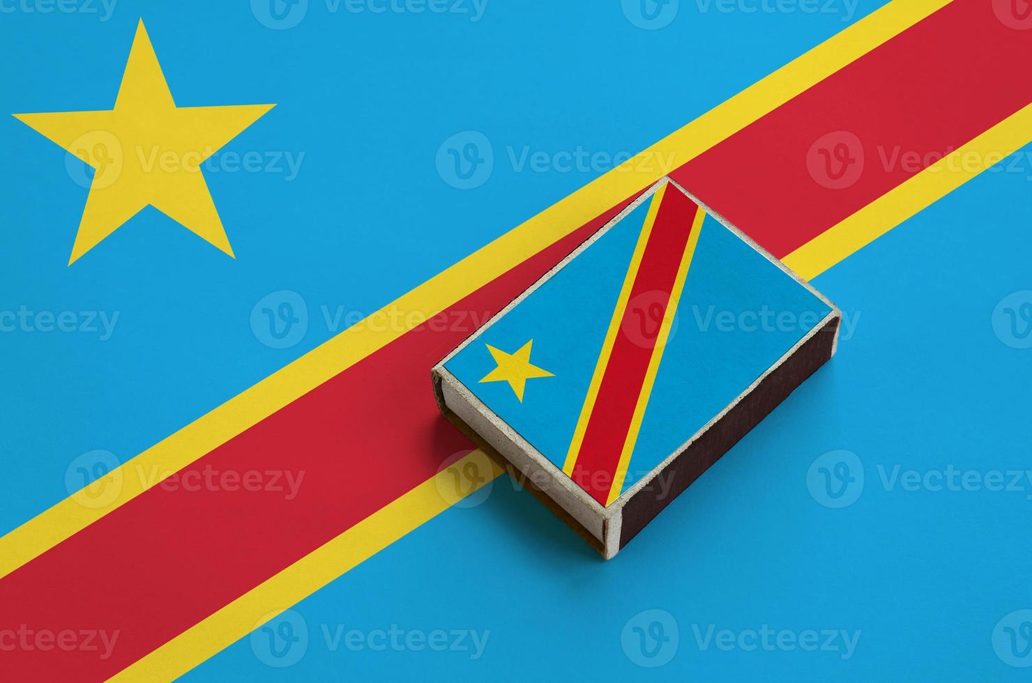 Democratic Republic of the Congo flag is pictured on a matchbox that lies on a large flag photo