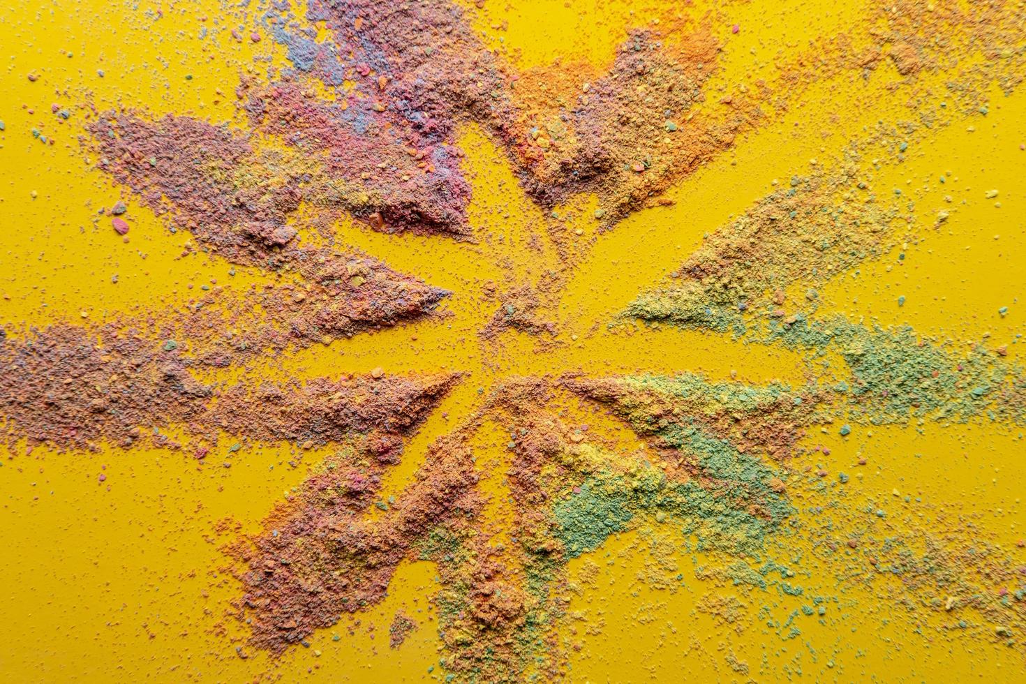 Bright star is drawn on a multicolored powder on a yellow background. Holiday concept. Beautiful postcard. Top view. photo