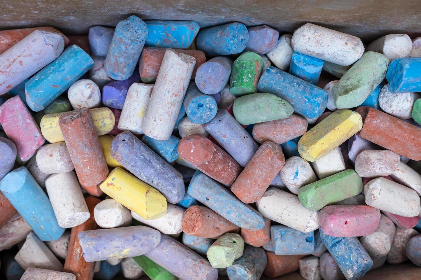 Pile of colored crayons. Multi-colored bright pieces of chalk. Top view. photo