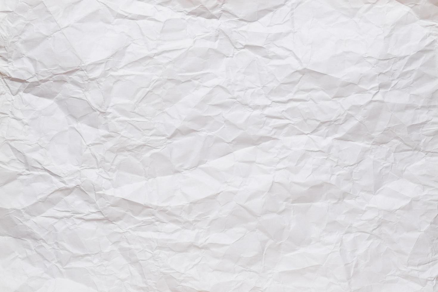 Crumpled, straightened sheet of white paper. Textured background. Copy space. Top view. photo