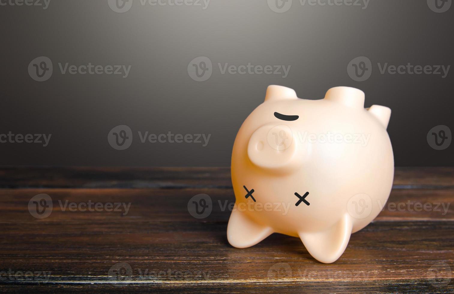 Dead piggy bank lies upside down. Economic depression. Financial crisis, end of savings, bankruptcy. Devaluation, inflation. Impoverishment. Refinancing restructuring of debts. photo