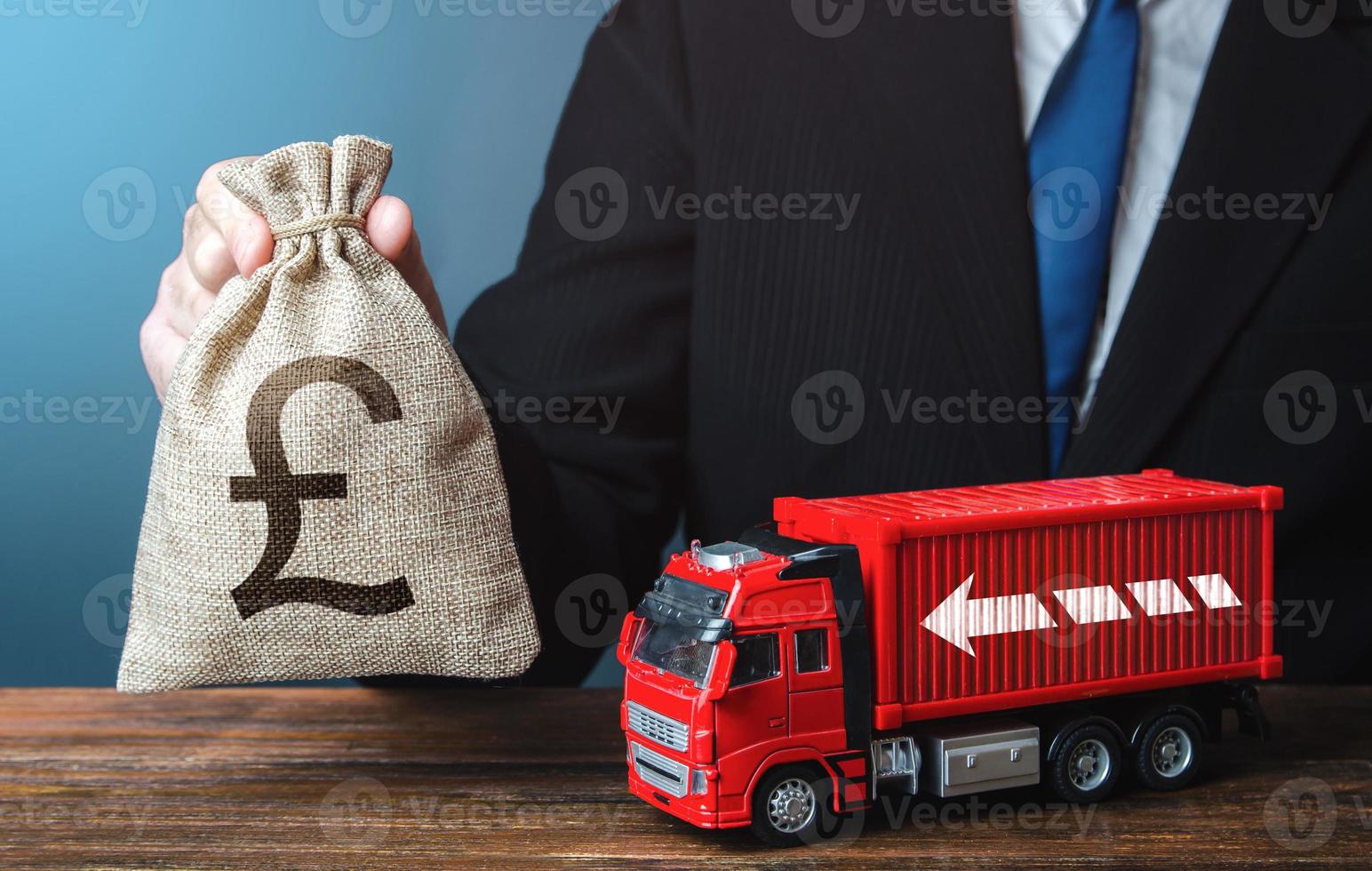 Businessman with british pound sterling money bag and truck. Good salaries for drivers. Rising prices, global containers shortage crisis. Logistics. High income of the transport business photo