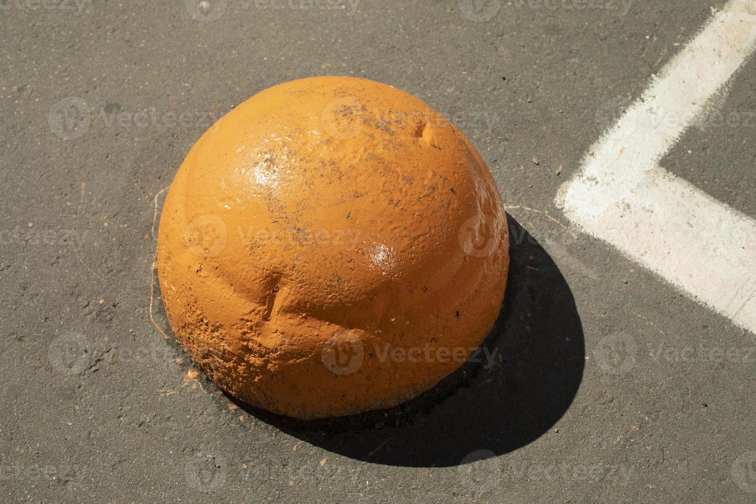 Orange motion blocker. Parking post. Sphere for transport. photo