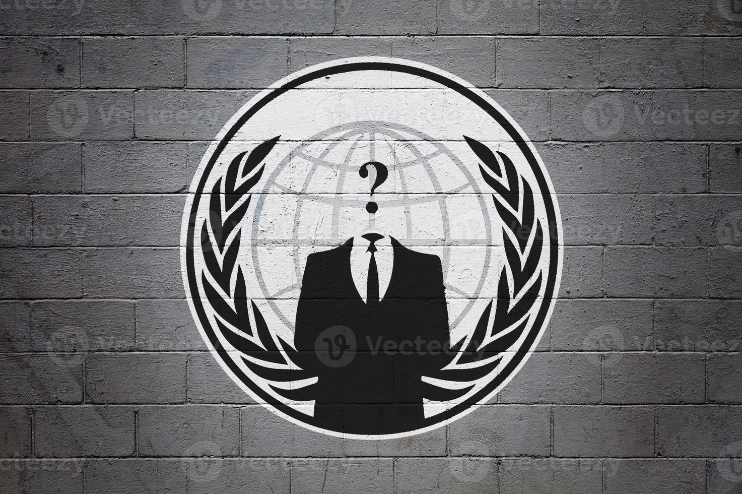 Flag of the Anonymous on brick wall photo