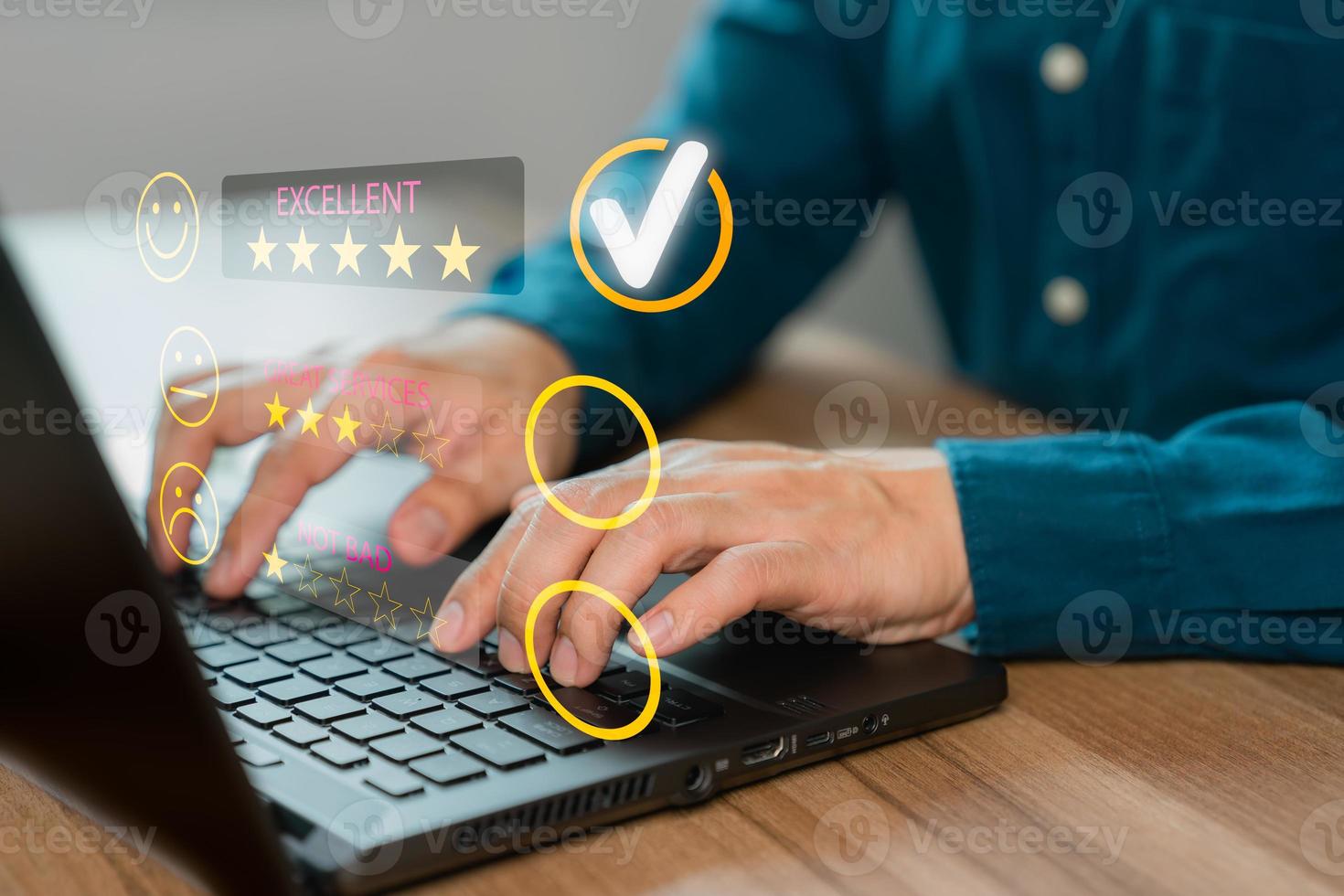 Man hand using computer laptop with popup five star icon for feedback review satisfaction service, testimonial. Customer service experience and business satisfaction survey. photo