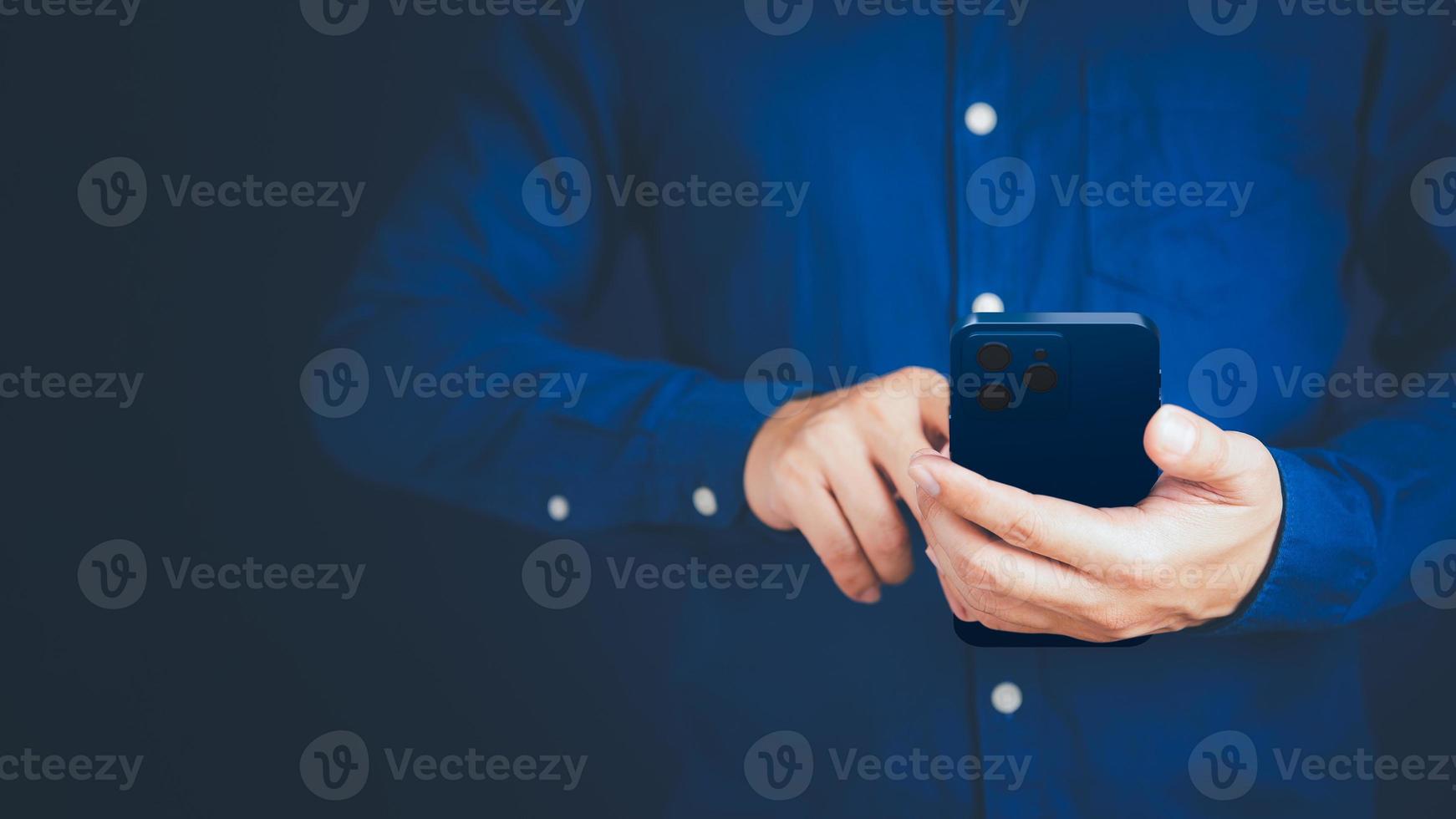 Businessman texting on mobile phone in his office. Communication, work or meeting, connection, mobile apps, technology. Young man using smartphone at home. Lifestyle working concept. photo
