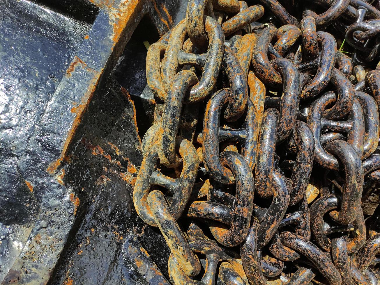 Rows of old rusty ship anchor chain links, close-up photo