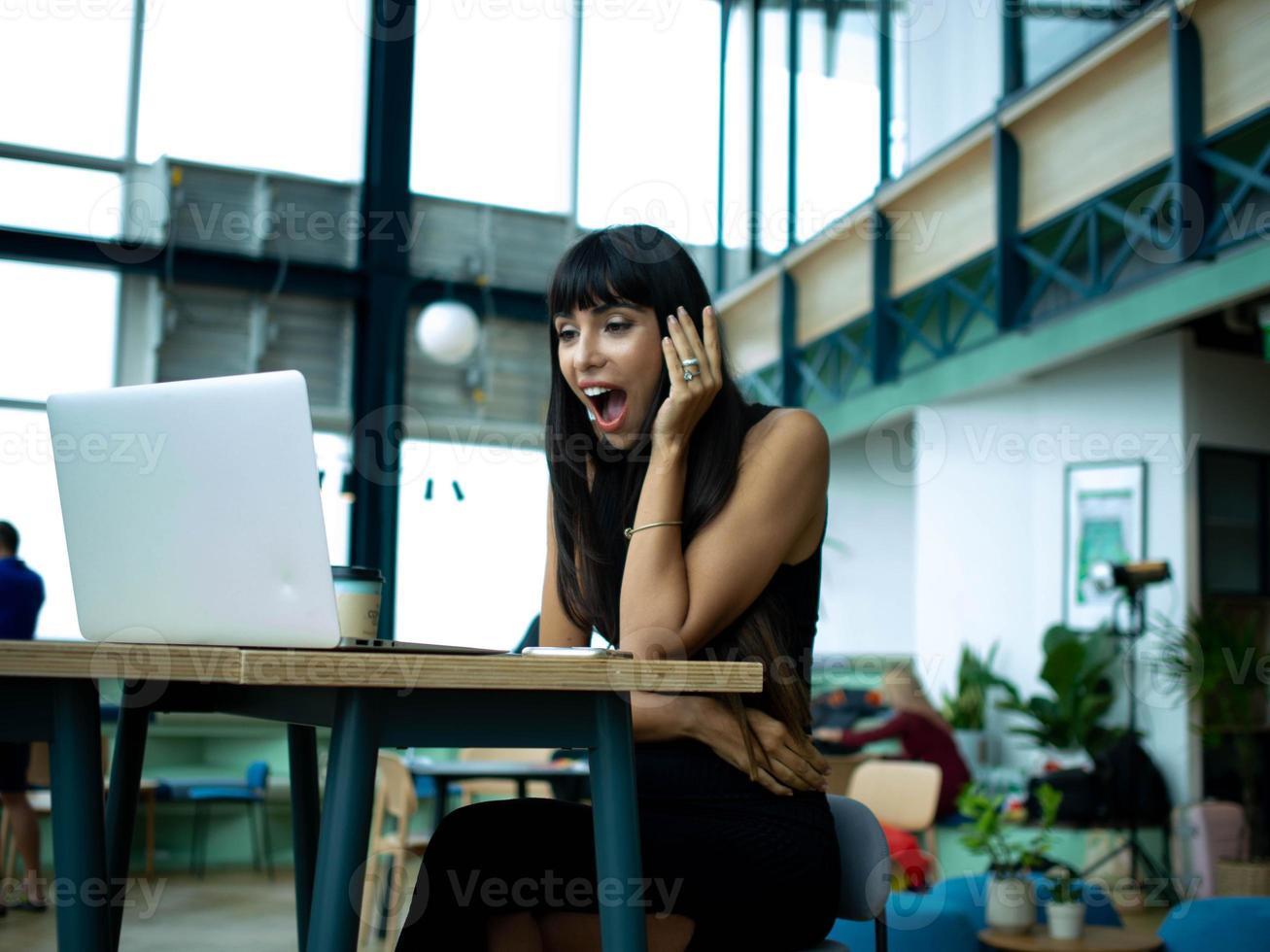 Businesswoman female girl lady young adult person people beautiful pretty look at notebook laptop computer technology digital wow emotion smile happy business indoor office company amazing wonderful photo