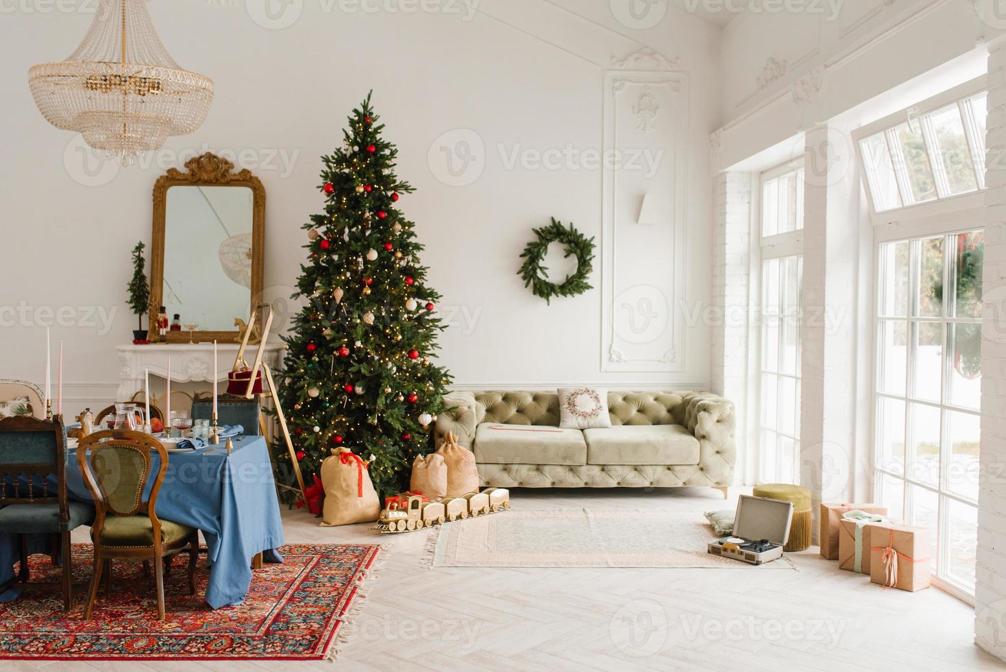 Classic Christmas New Year interior of the room is decorated with a Christmas tree. Christmas tree with gold and red decorations and gift boxes. Christmas Eve at home photo