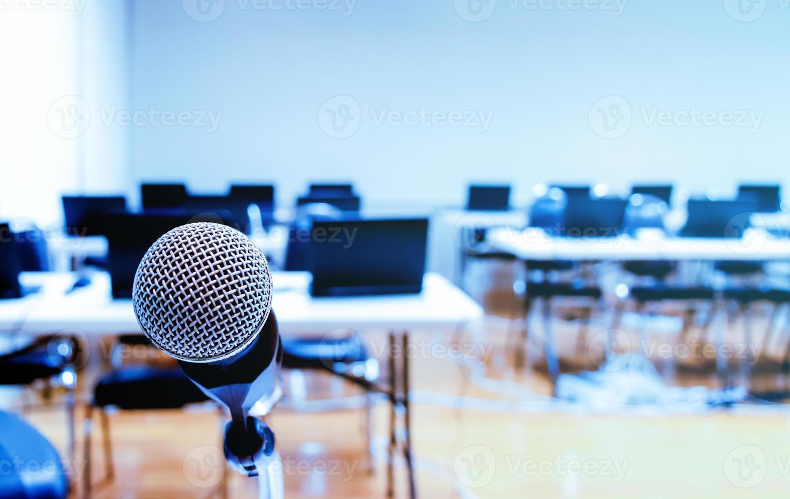 Close up microphone with laptop on table background in seminar room photo