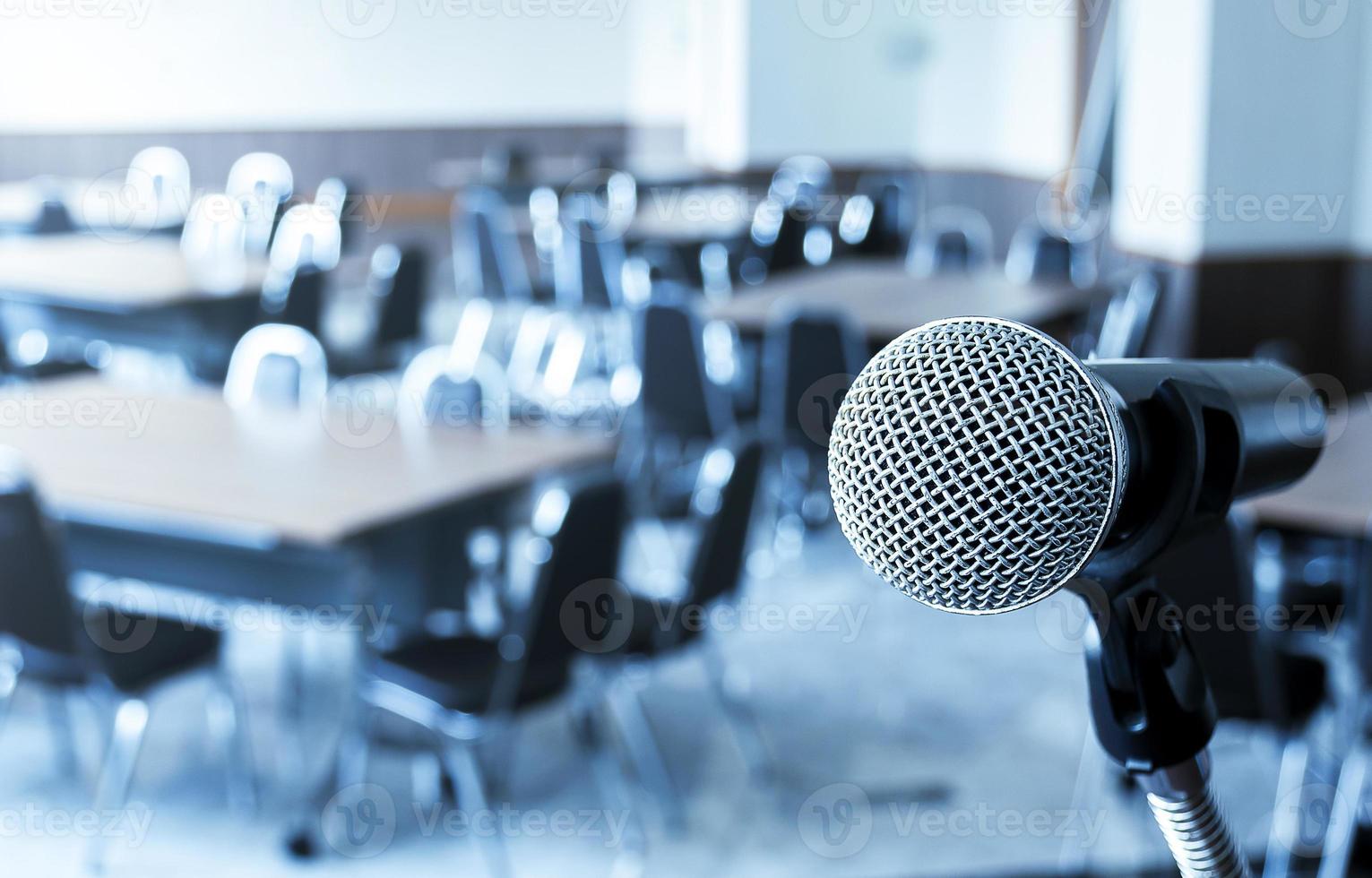 Microphone with tripod on stage in seminar room and copy space photo