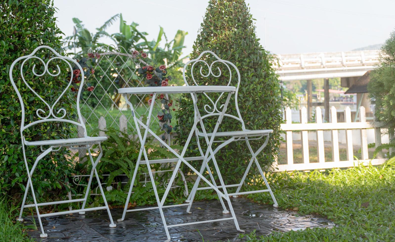 Garden living corner with white metal table and chair set photo