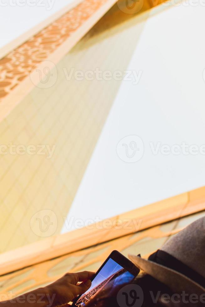 Dubai, UAE, 2022 - woman tourist visit Frame landmark in Dubai take photo of modern beautiful architecture city buildings