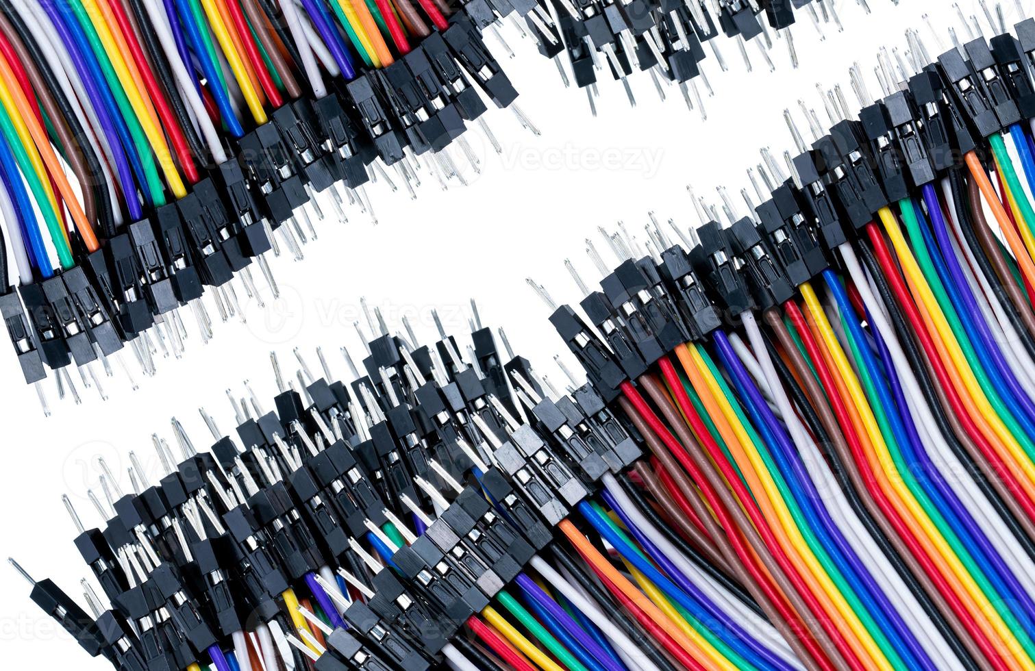 Ribbon cable or multi-wire planar cable on white background. Flat ribbon cable with pin connectors. Multi-colored ribbon computer connecting cable. Connecting pins. Electronic component of computer. photo