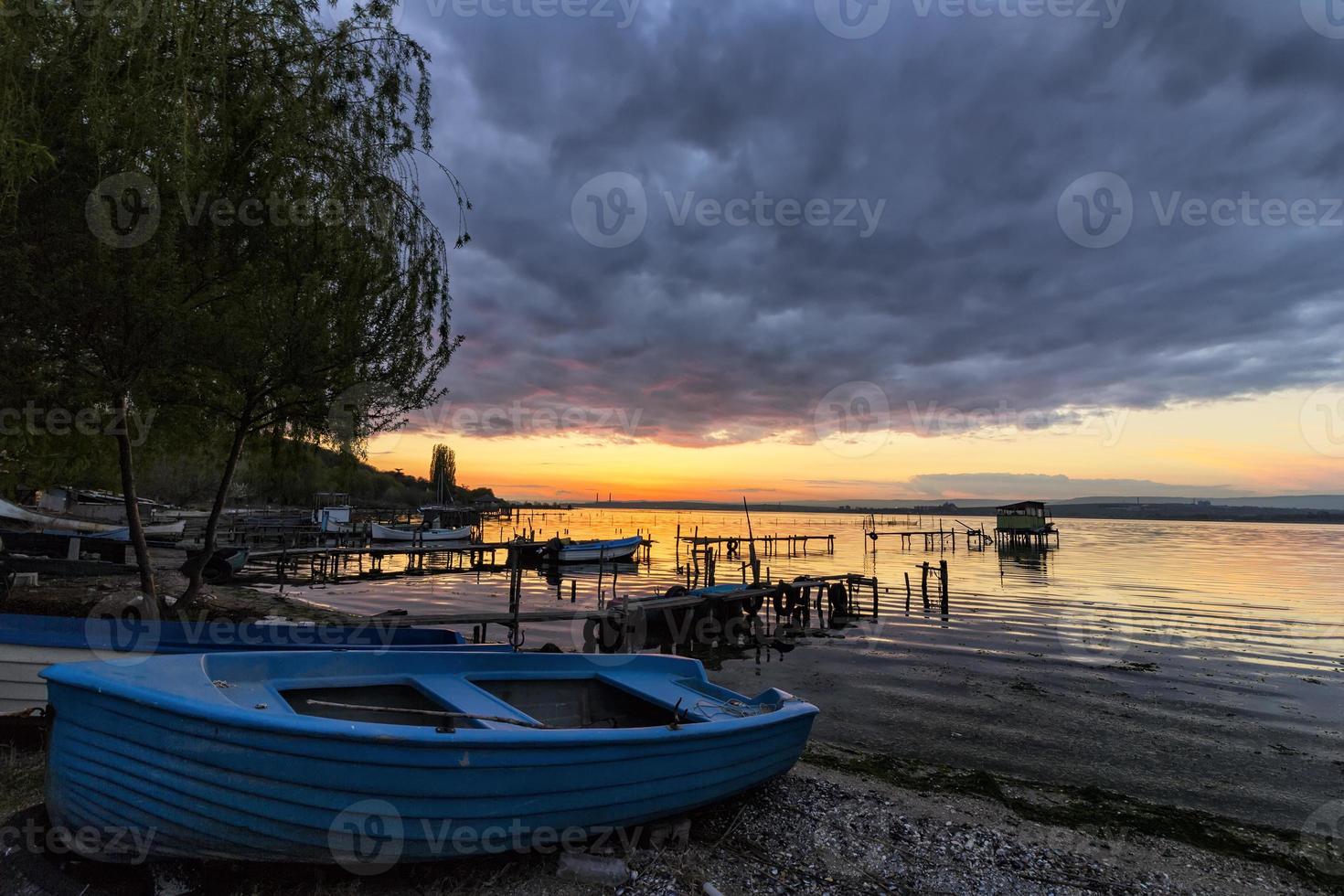 fishing boat on the beach at the sunset photo